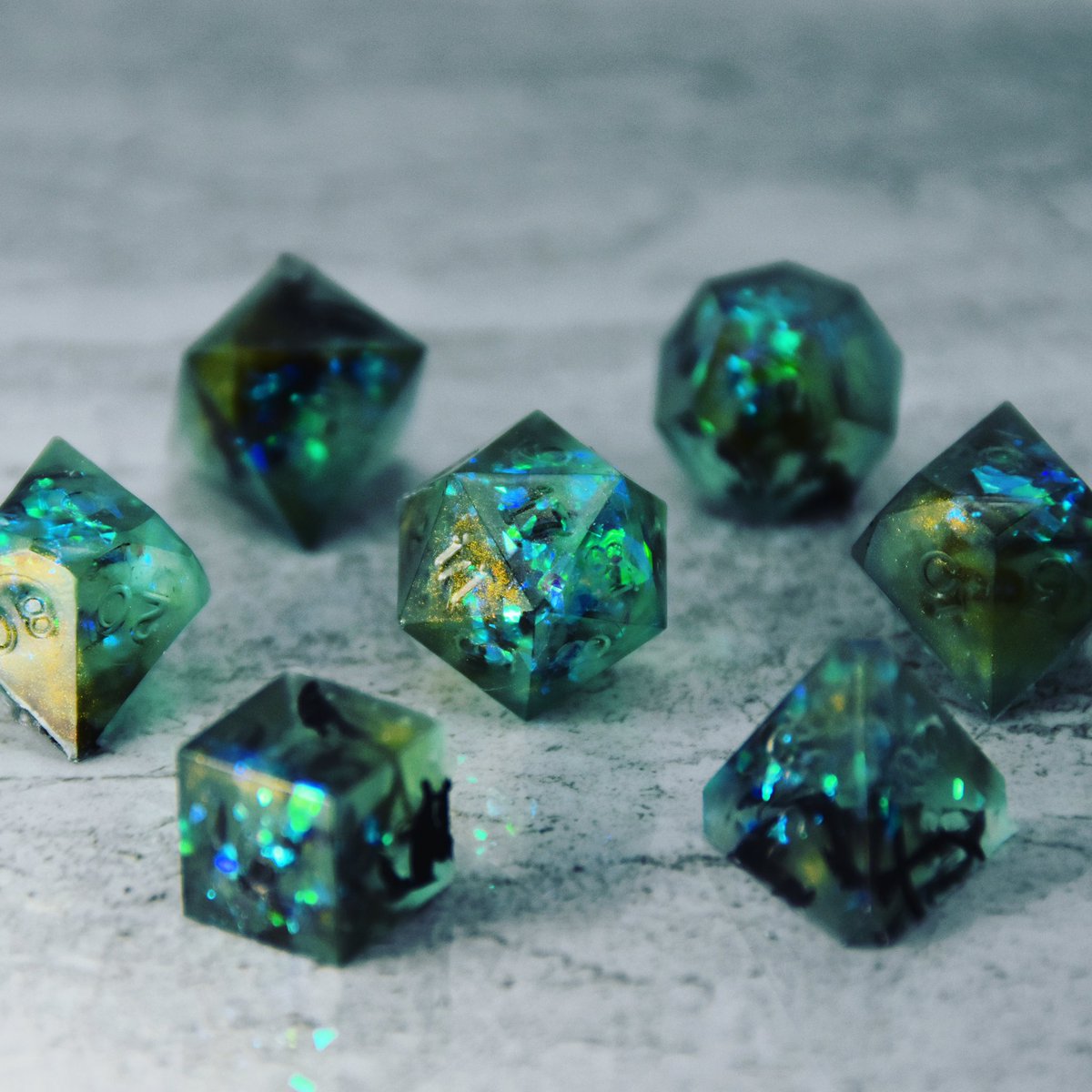 Another attempt at some Cthulhu inspired dice with black smoke tendrils in iridescent aqua green waters! Numbers will be painted, dice are not edible, and you can sign up for email updates regarding sales at dispeldice.com! 🦑🐙🌊