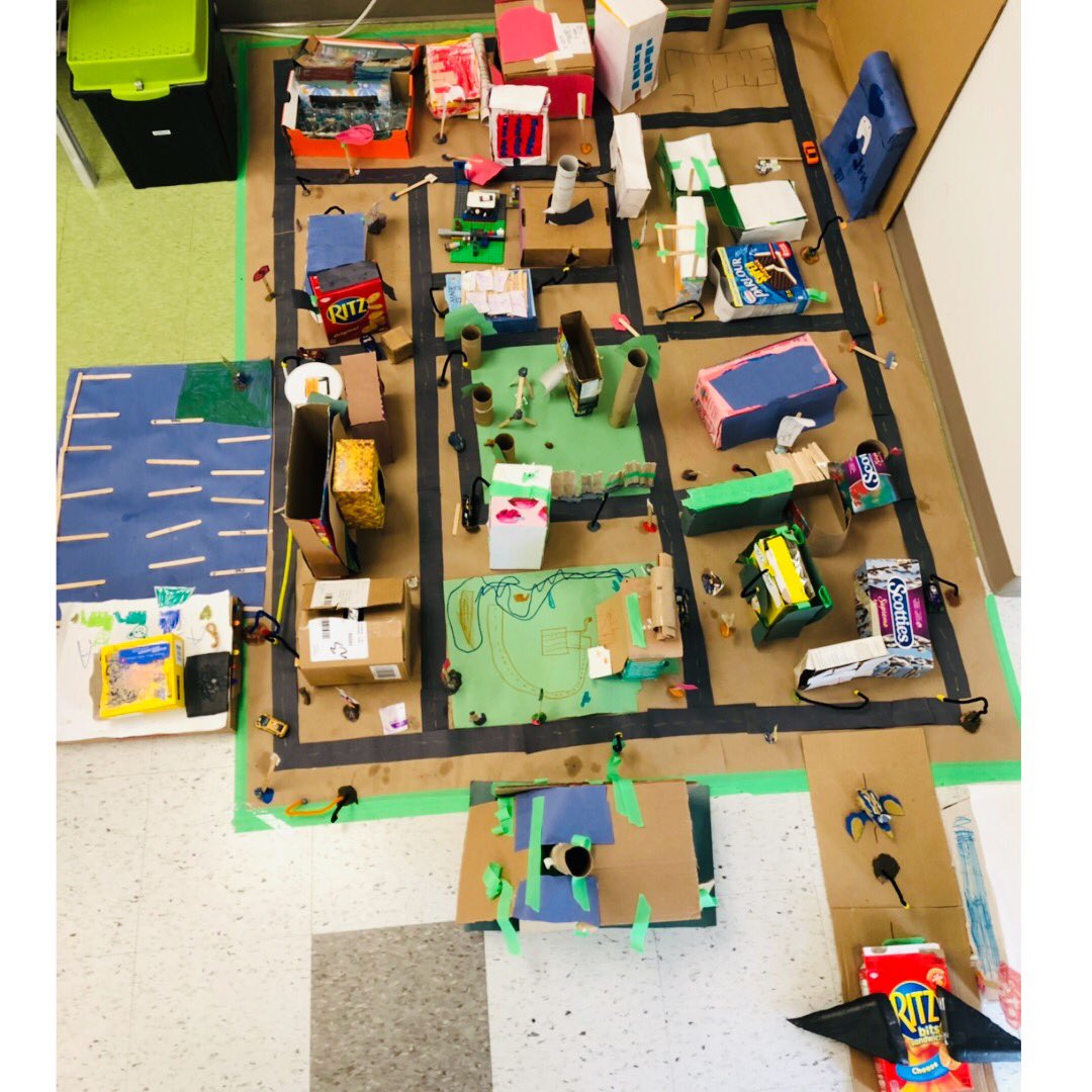 Wow!  The whole class collaborated together to build a community out of re yvled materials!  Complete with street lights, street signs, and even some community workers!  @newhalfmoonbay #creativestudents #ourcommunity #reuserecycle