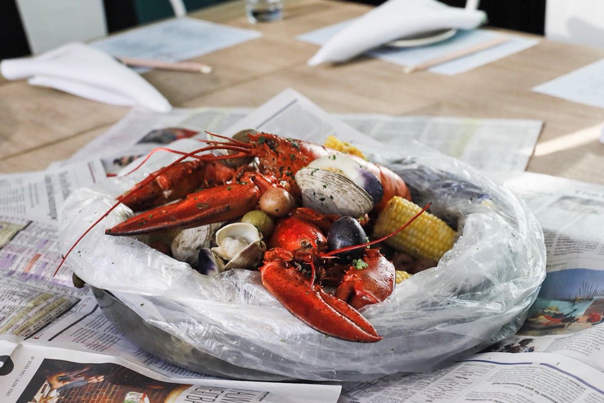 Our Boils and Bakes dish is two 2lbs of crab stuffed lobsters with boiled clams, mussels, corn and potatoes, only at the Side Room at Saltie!