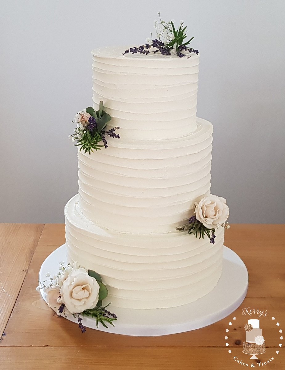 Kerrytuckercake's tweet photo. Simplicity at its best today for Tom &amp; Clarissa's wedding cake! With delicious flavours of lemon &amp; elderflower, white chocolate &amp; raspberry and classic vanilla and finished beautifully with dainty flowers from @suzanneevettsflowers #buttercreamweddingcake #rusticweddingcake https://t.co/30j3eAvCrT