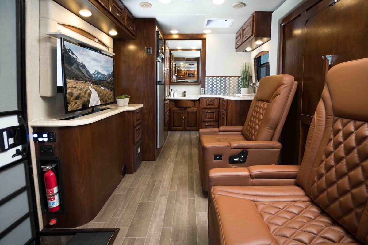 Regency_RV's tweet photo. With the push of a button, the large screen TV raises from its cabinet into position to view while in bed. With the lounge chairs in place, view the TV in the up position, or the down position through a clear panel.
#ultrabrougham #camptrends #rvliving https://t.co/Pw9TNXNraw