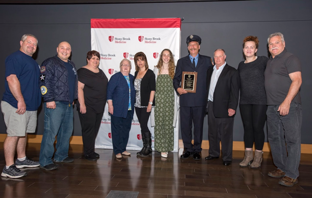 FDNY's tweet photo. Congratulations to #FDNY Firefighter Cliff Lesmeister #Engine262 who was awarded the “Heart Saver Community Award” by @StonyBrookMed for his role in saving a life while off duty. (Photo cred: Jeanne Neville) Read more: https://t.co/kOScx2SS7c https://t.co/FUDuhLmY1S