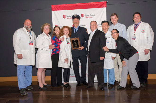 FDNY's tweet photo. Congratulations to #FDNY Firefighter Cliff Lesmeister #Engine262 who was awarded the “Heart Saver Community Award” by @StonyBrookMed for his role in saving a life while off duty. (Photo cred: Jeanne Neville) Read more: https://t.co/kOScx2SS7c https://t.co/FUDuhLmY1S