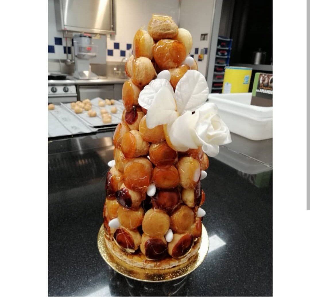 Le Cordon Bleu Croquembouche Or Cream Puffs Dipped In Caramel Stacked Upon A Nougatine Base And Garnished With A Pulled Sugar Rose A Breathtaking Piece Made At Le Cordon Bleu
