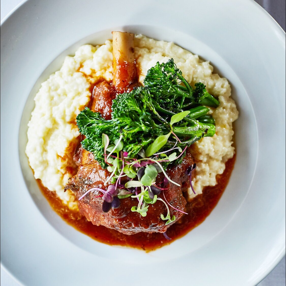 TableAndMain's tweet image. #ThrowbackThursday to this lamb shank with smoked grits we ran on 2017’s winter menu! 🍖