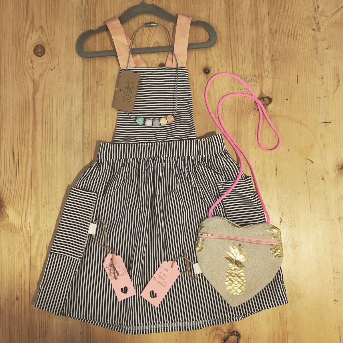 We just adore these @littlesewingodyssey pinafores - lovingly handmade in #e17, and available up to 6 years. Looking great with a <a href="/ELDNBC/">East London Baby Co</a> necklace #handmade #walthamstow #pinafore #cotton #carrotandcotton #spanishchildrenswear #pineapplepattern #stripes