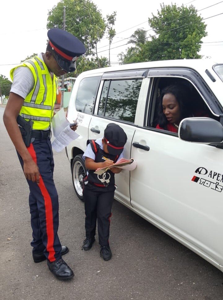 Career Day in Jamaica -This little police officer is issuing a ticket. This is an annual event for children from reception - a day to dress as a professional ( and act the part) 
#careerdayJamaica #Jamaica #Jamaicalandwelove #sweetJamaica #🇯🇲