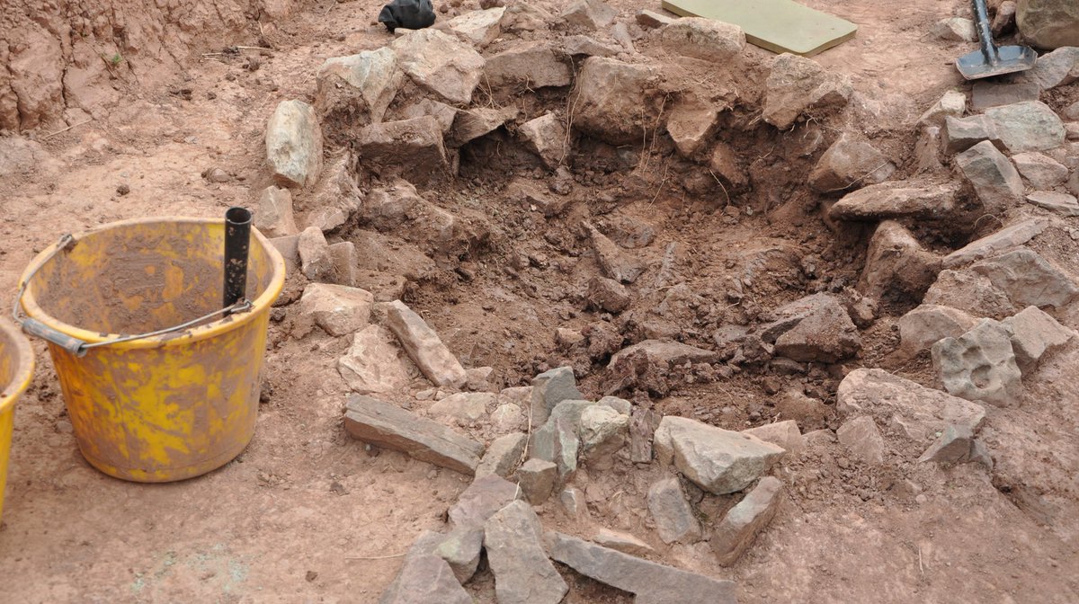 UoBristolHARP's tweet photo. Well, what do we have here! Students are currently busy excavating a well, and have found animal bones and stones within the feature. More to come! #digberkeley https://t.co/tE4dsXEG7F