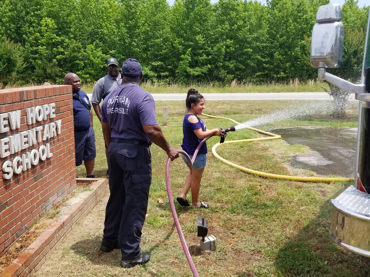 Depty Chief Travis Richardson,  Assistant Chief Tyrone Terry and  Fire Chief Daren Small surpervise Rebecca in operating the firehose.