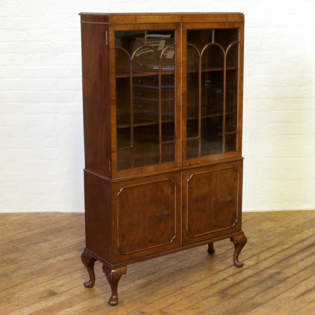 witchantiques's tweet photo. A 1920's Queen Anne style Walnut cabinet with detailed burr walnut veneers to the bottom doors and arched astragals to the windows. https://t.co/6p88UvLn7y