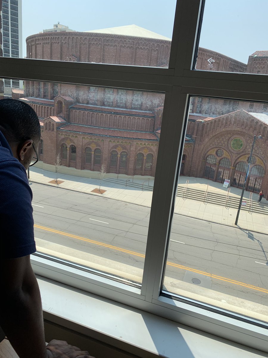 Happy Friday. Please enjoy this photo of  @juliusljones gazing out of our office window at the people enjoying the beautiful weather outside. This ritual marks the beginning of “Let’s Go Eat Lunch in the Park” season here in Chicago.