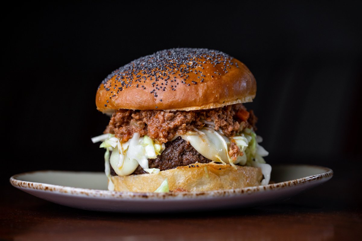 dineLA's tweet photo. Up your burger game with the Bolo Burger at @rossobluLA featuring a prime beef patty topped with house-made cheese and blanketed in ragu bolognese ๐คค. Pro Tip: Available on Sundays only, so plan accordingly! #dineLABurgerTrek #rossoblula #artsdistrict https://t.co/RR1027wTSY