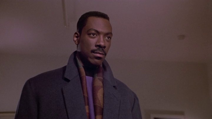 Eddie Murphy plays Marcus Graham, a womanizing Advertising Executive. Layering is the watchword for him as he pairs his suits with stylish coats and complimentary scarves. Even his haircut inspired a legion of playboys who followed suit.