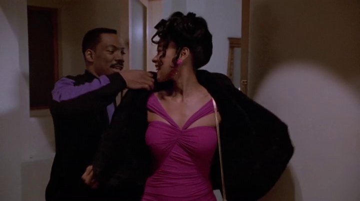 Despite playing a minor character, Lela rocks one of my favorite outfits in the entire movie. She looked gorgeous in this pink cocktail dress.