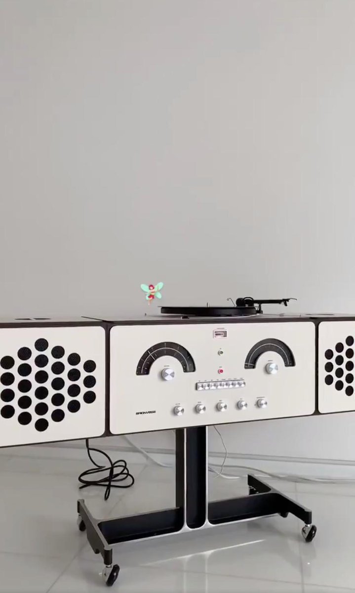 krystalxart's tweet photo. krystal is using a mid-century modern brionvega turntable that was manufactured in the 60s by pier giamcomo and achille castiglioni. the shape of the record player can be stacked or removed to create various shapes. david bowie's own custom brionvega sold for £257k in 2016. https://t.co/kmIaNONYhy