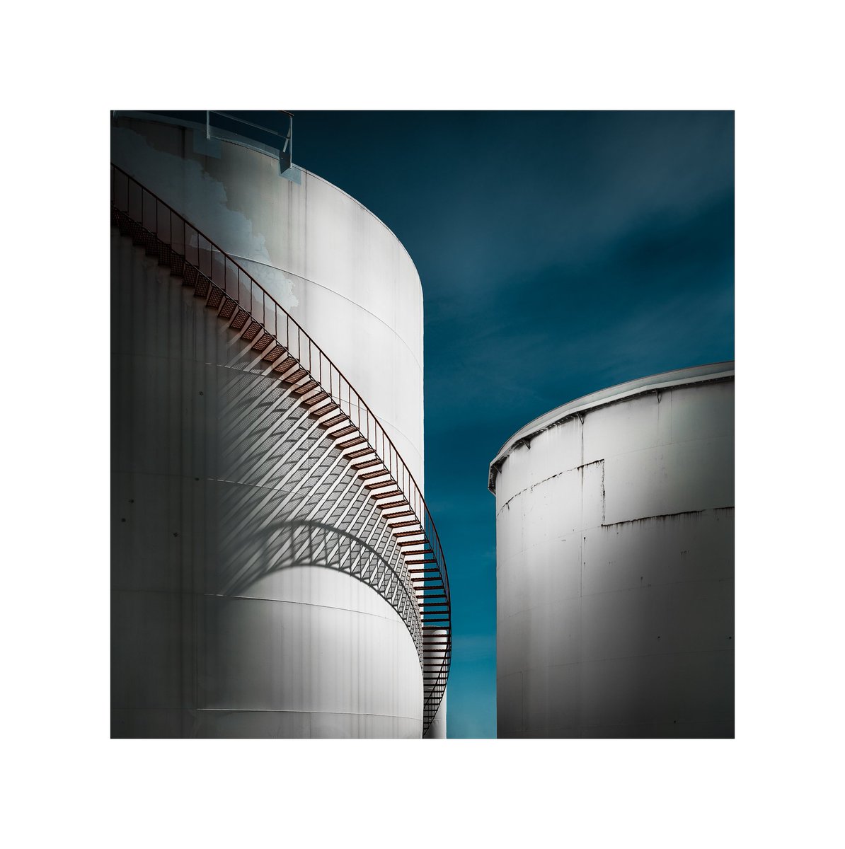 The Tank Farm
This was not an easy shot as the fence was tall and I had to raise my hands to shoot through the fence.  The shadows of the stairs caught my attention from afar and I just had to stop for me to steal a couple of shots.

#hasselbladX1D #hasselblad #createtoinspire
