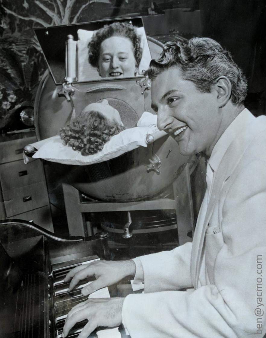 Ben_Hawkes's tweet image. Just in case you need it this morning, here's the picture of Liberace playing piano for a lady in an iron lung.