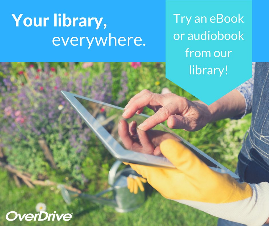 a woman holding a tablet in the garden