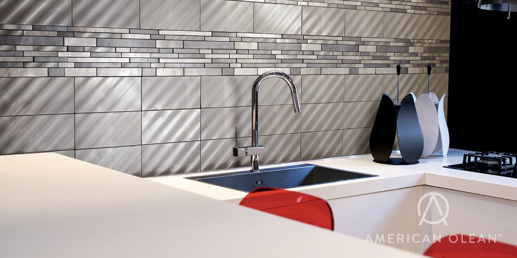 aonews's tweet photo. The height of design with texture, shape, and a touch of bling - Refined Metals in Stainless - pictured here in Linear Wave and Gunmetal interlocking #mosaic is a focal point in this kitchen.  #TileTuesday #tile https://t.co/JP9O6s6JY3