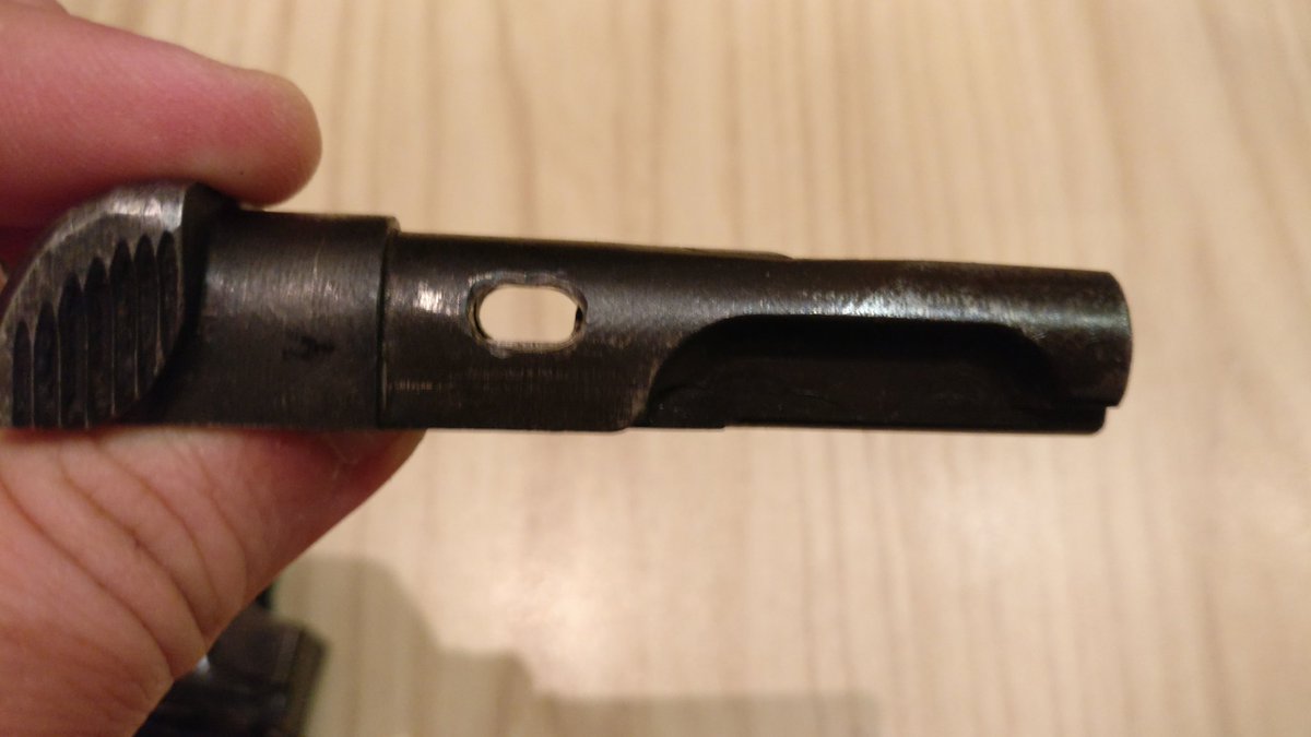 The disassembly of the slide features a cross-bolt type block held in place with the firing pin in the two consecutive pictures one can see the firing pin protruding and locking in the cross-bolt.