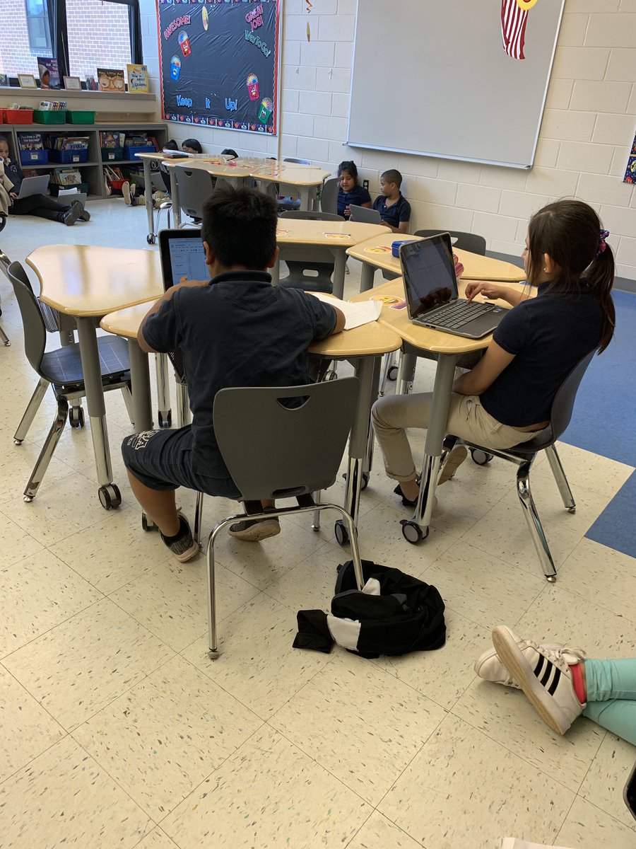 Section 2 working together on their social studies project on Google Slides