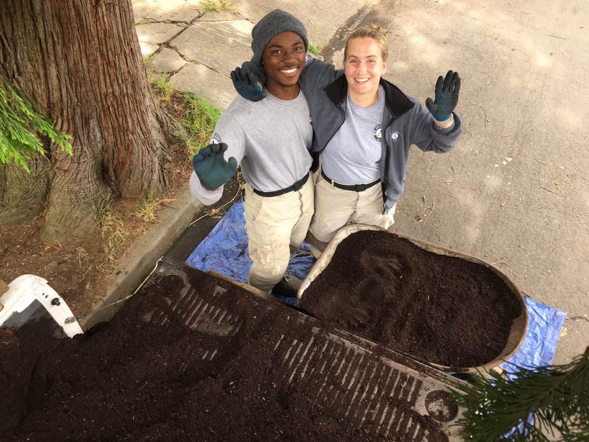 AmeriCorps NCCC team Blue 1 moving compost for sheet mulching!