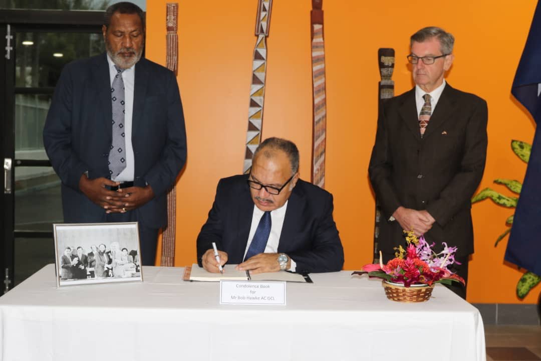 pm_nec's tweet photo. Prime Minister O’Neill’s signing a condolence message to the Family of late former Australian PM Bob Hawke, which read:

"Our nation's sympathy to the family and people of Australia on the passing of a great friend of Papua New Guinea the late Bob Hawke.” https://t.co/rMP4IGGxWW