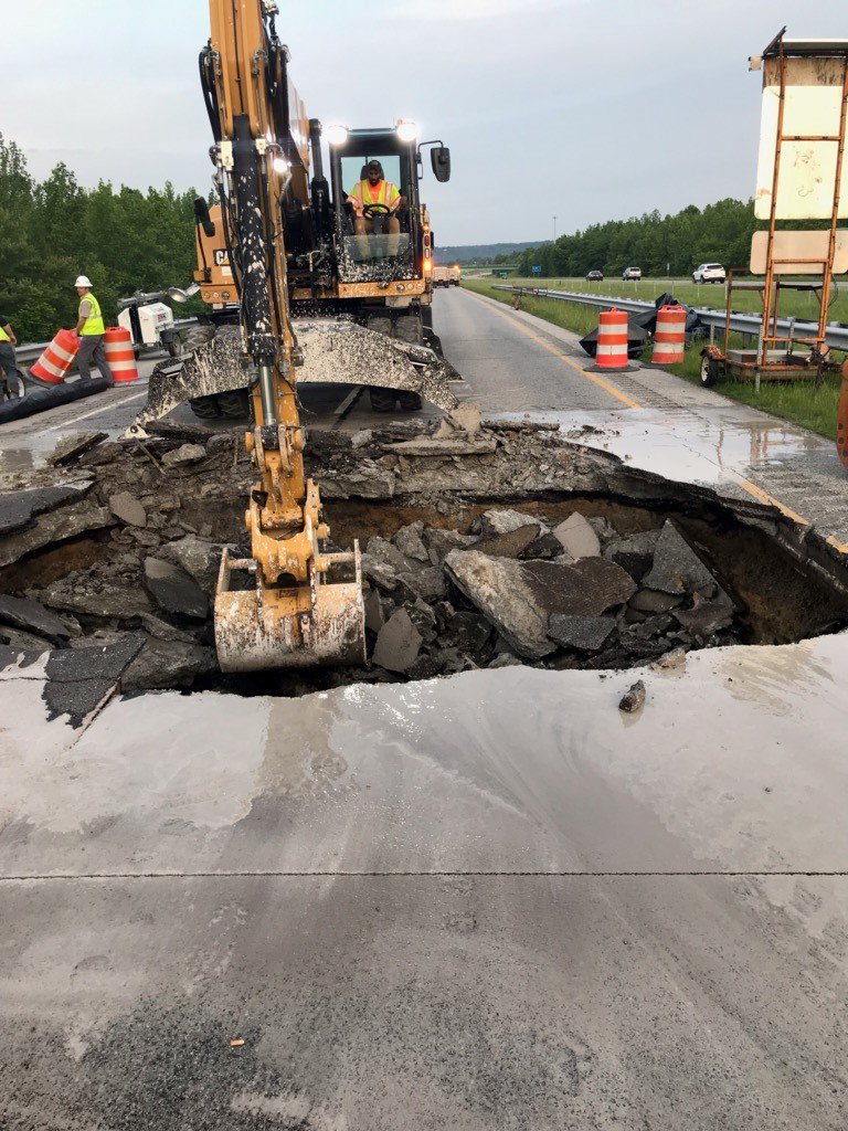 INDOTSoutheast's tweet photo. Work has been in progress since early this morning to repair a sinkhole on I-265 EB in Floyd County. These photos were taken after crews broke open the roadway to make repairs. The hole is being filled and then capped with asphalt. I-265 EB is expected to reopen this evening. https://t.co/0F6vFcrxa0