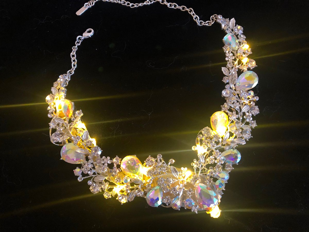 firepixie's tweet photo. I made a pretty thing that lights up! This one's #easypeezy -- and only about $5 in electronics!  #lednecklace #diy #glowup @adafruit  https://t.co/fHYsdaGmDU https://t.co/4PJknDT2k8