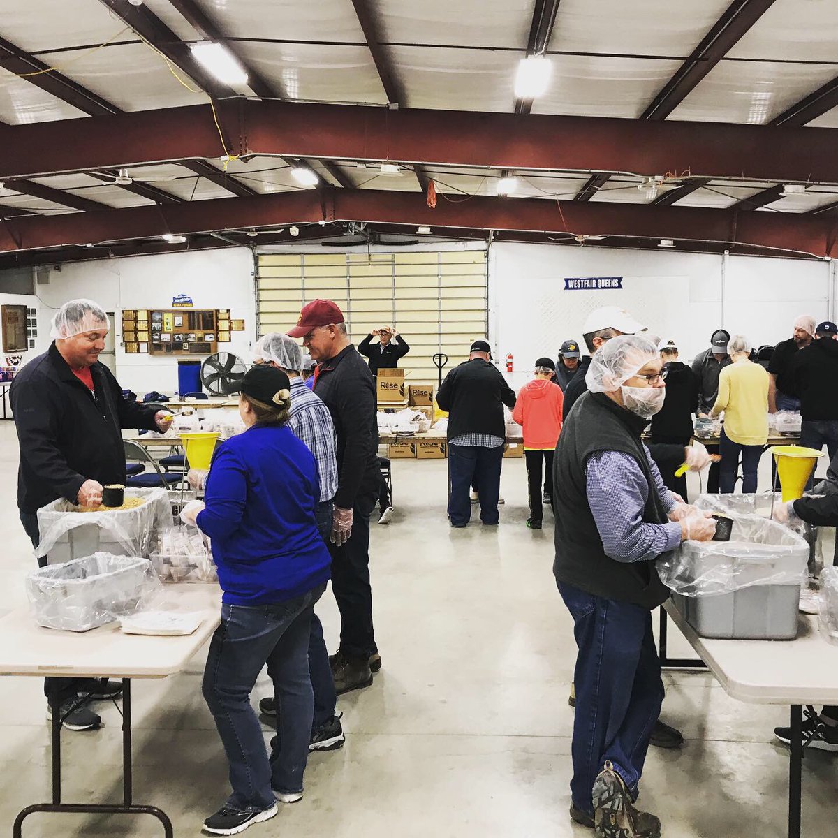 HuschBlackwell's tweet photo. A #HBOmaha team of attorneys, staff and #HuschPuppies donned gloves and hats to join host #Syngenta and other organizations in packing meals at a @Rise2030 event Tuesday. #Riseagainsthunger is a global movement to end hunger by 2030. #2030ispossible #HBGivesBack #JoinHB https://t.co/a6I9qAGzmr