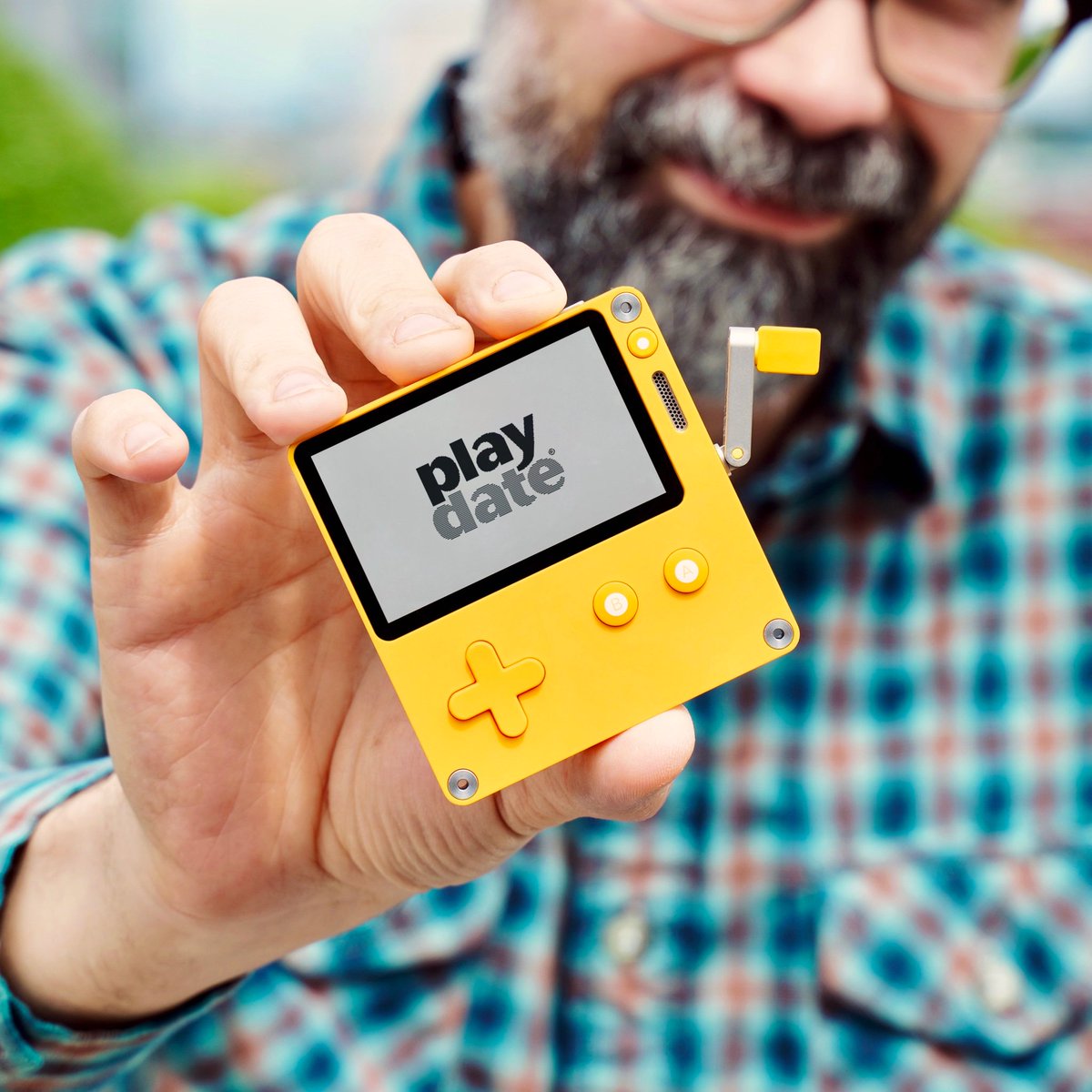 Photo of me holding a cute yellow handheld console