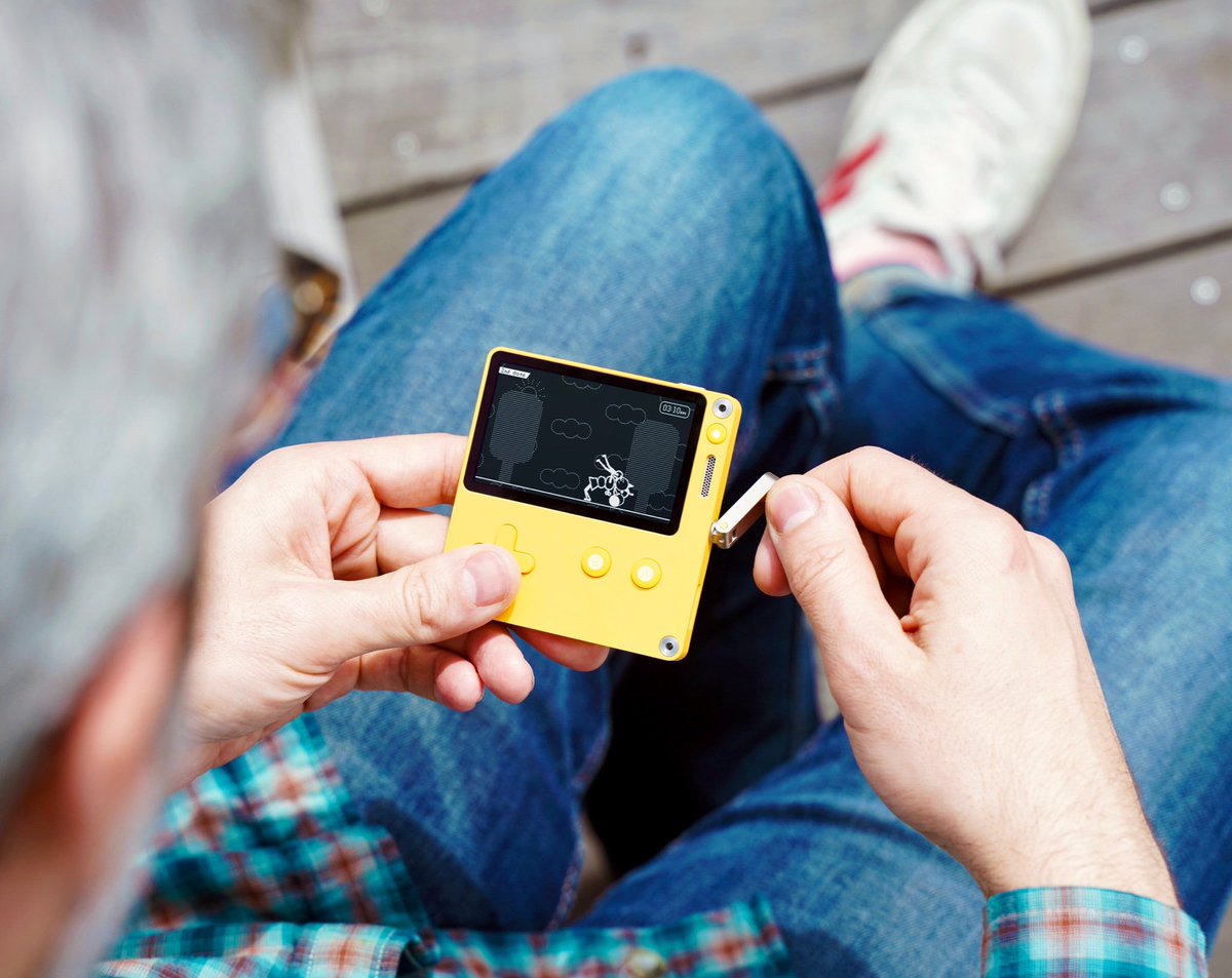 Photo of me playing a cute yellow handheld console