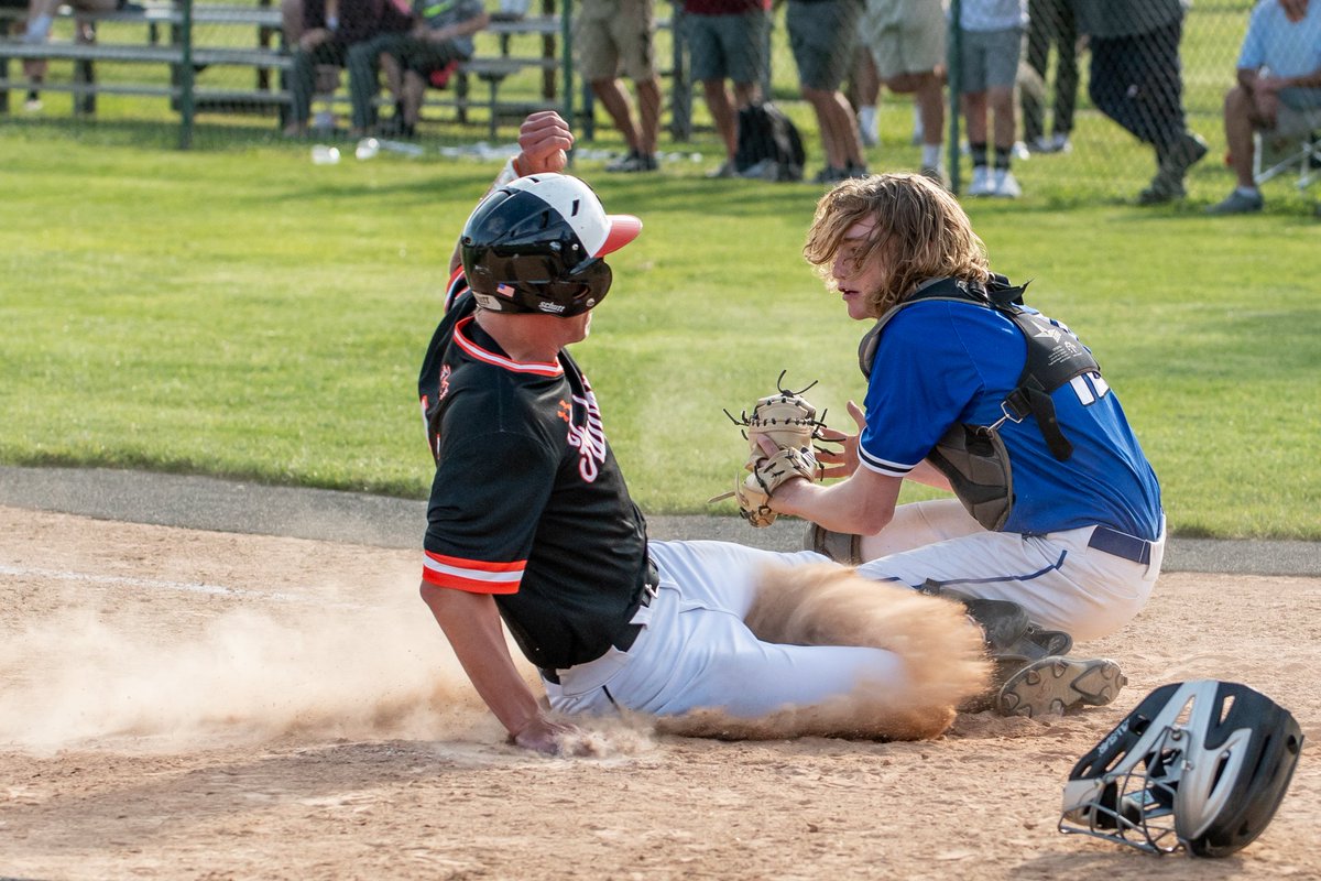 In a close call, CB South's Dylan Gruber attempts to stop a run as Pennbury's R.J. Huth slides home during today's district playoff game.