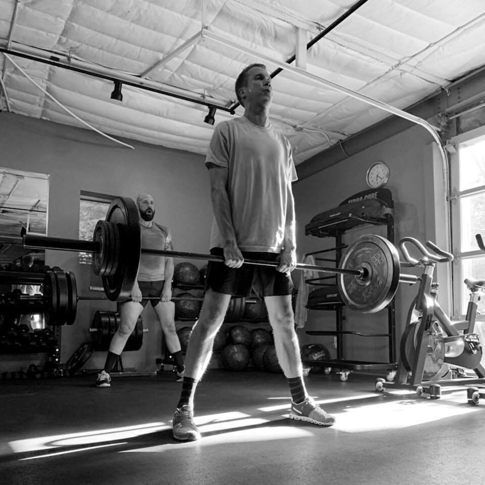 When you go to set up for a sumo dead lift, set your grip about shoulder distance apart. This will allow you to move the bar closer to straight up and down and not have to move the bar around your knees.