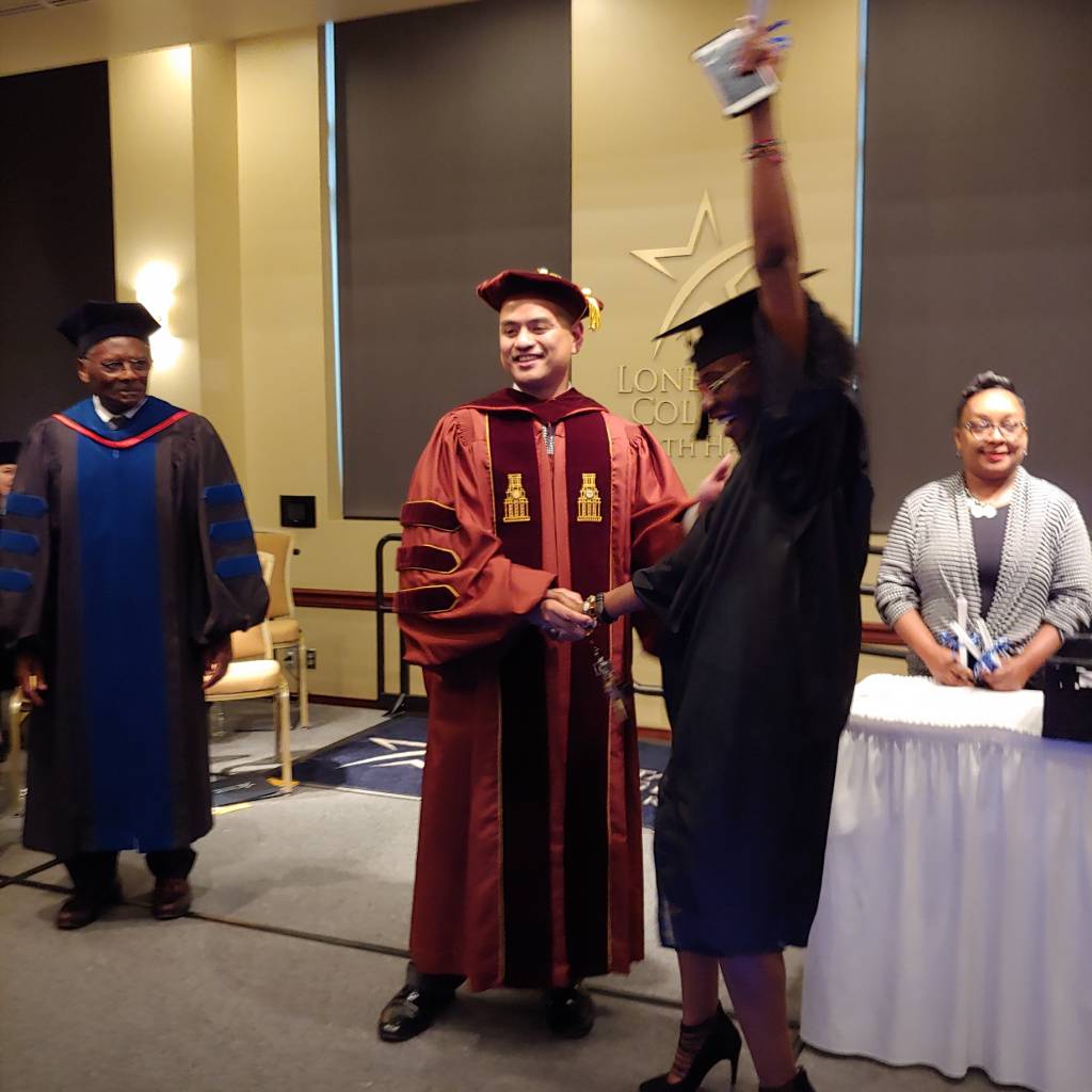 LSCNorthHarris's tweet photo. After Board of Trustees Ernestine Pierce fired up the crowd with her theme song, she exchanged hugs with the graduates. Then Dr. Gerald Fernandez Napoles, President, LSC-North Harris, and Dr. Alton Smith, Board of Trustees Chair, presented certificates. @NHarrisNation @kappasmith https://t.co/2CO8zrdNK8