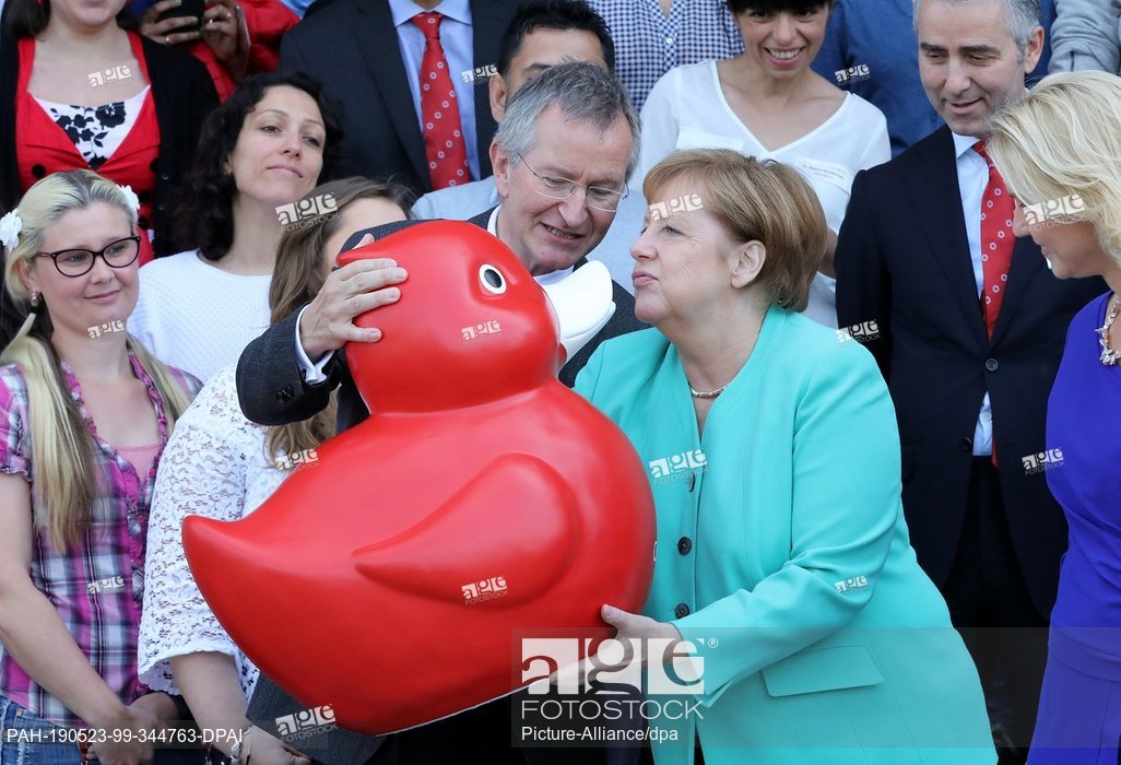 German Chancellor Angela Merkel receives a red duck toy from Arndt Rolfs, CEO of Centogene AG as she visits biotech company Centogene in Rostock. May 23, 2019 - Mecklenburg-Western Pomerania, Rostock. More 📷: agefotostock.com/age/en/press/i…