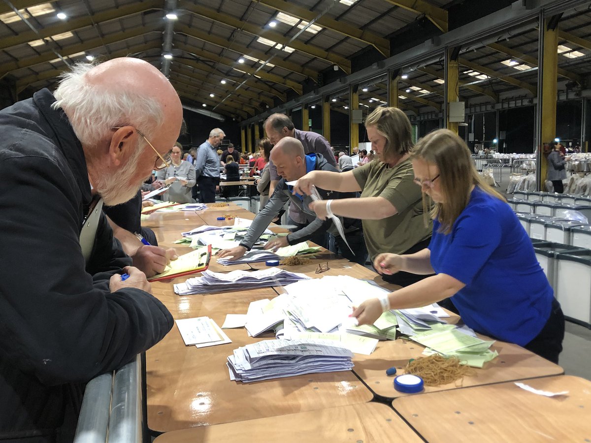 Here’s an example this morning. As each box is opened, with the ballot papers separated and straightened out, there’s a slip of paper displayed on the desk to tell you which ballot box you’re looking at.From that you can determine precisely which polling station it came from.