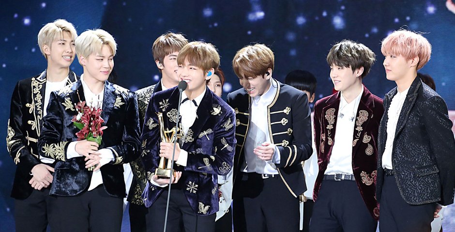 Boy Band BTS accepting an award on stage