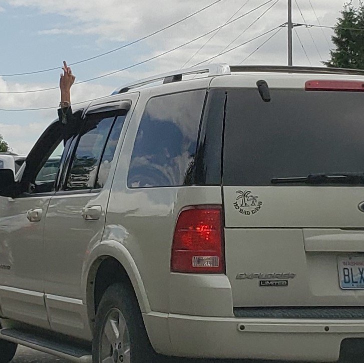 Contrary to the message on her tailgate....I think someone is actually having a bad day! Memorial Day weekend traffic in Seattle….🖕🖕😁😘