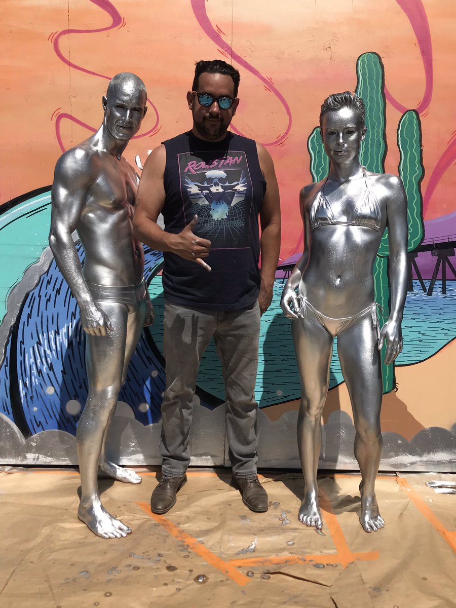 TrulyHermosa's tweet photo. Renowned body painting artist Paul Roustan is live in action creating his silver surfers. Amazing! Come swing by Fiesta de las Artes (near Laurel Tavern) to see for yourself. 🎨 https://t.co/Z65WhAj3rc