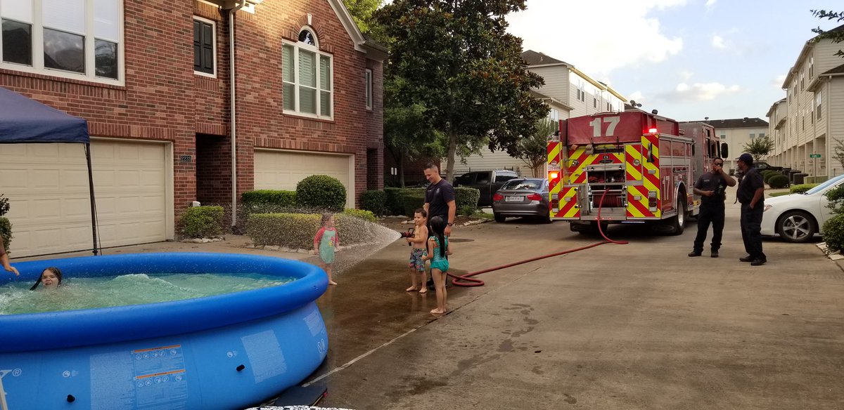 SheldraBrigham's tweet photo. Firefighters from Engine 17 enjoying kids in their district.  It’s nice to use the fire hose for something fun! @HoustonFire https://t.co/4lXPx7AJO5