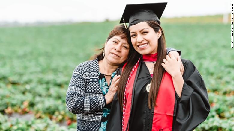 CNN's tweet photo. This college graduate honored her parents in her graduation photos, standing in her cap and gown, in the middle of the fruit fields where her mother still works.

"Their sacrifice to come to this country to give us a better future was well worth it." https://t.co/ATtBbCC376 https://t.co/PFpyCxH8IK