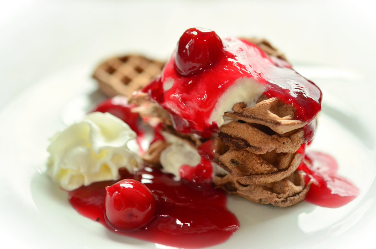Chocolate waffles, whipped cream and cranberry sauce