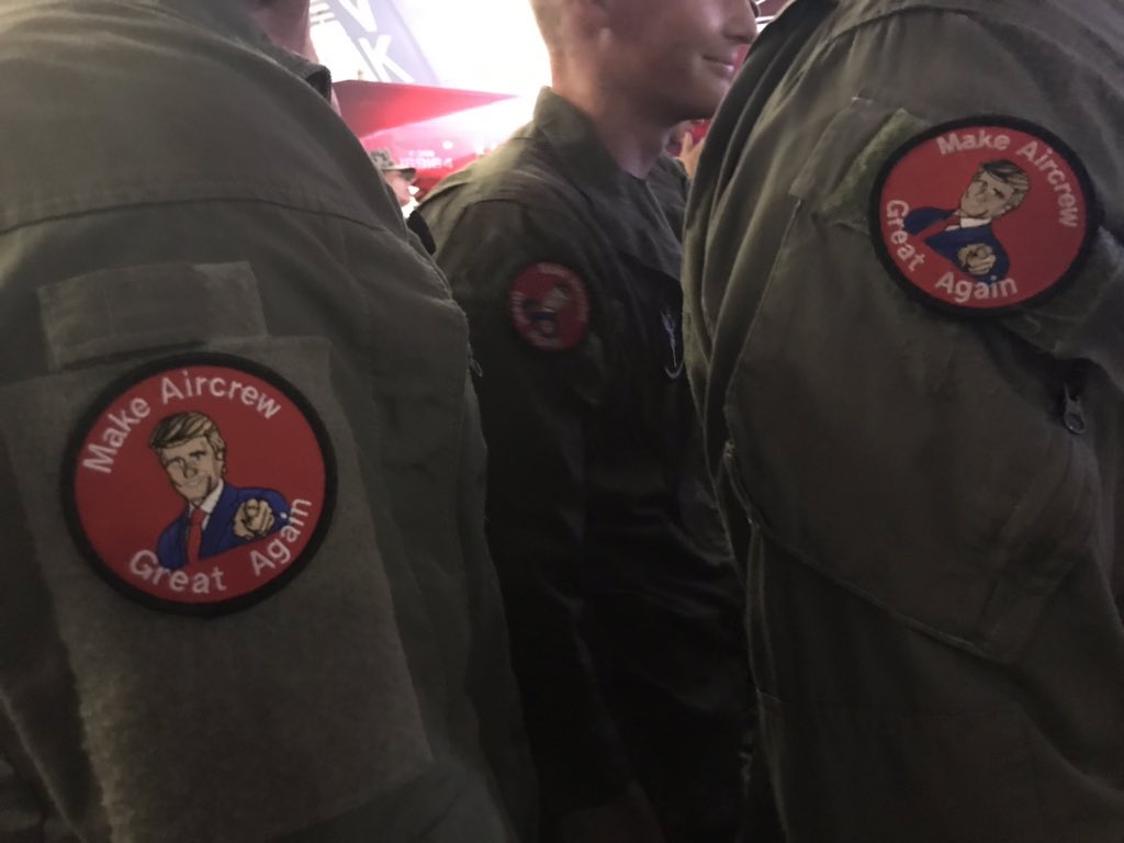 vmsalama's tweet image. Airmen onboard the USS WASP wearing patches on their jumpsuits that read “Make Aircrew Great Again.” The patches include an image in the center in the likeness of President Trump.