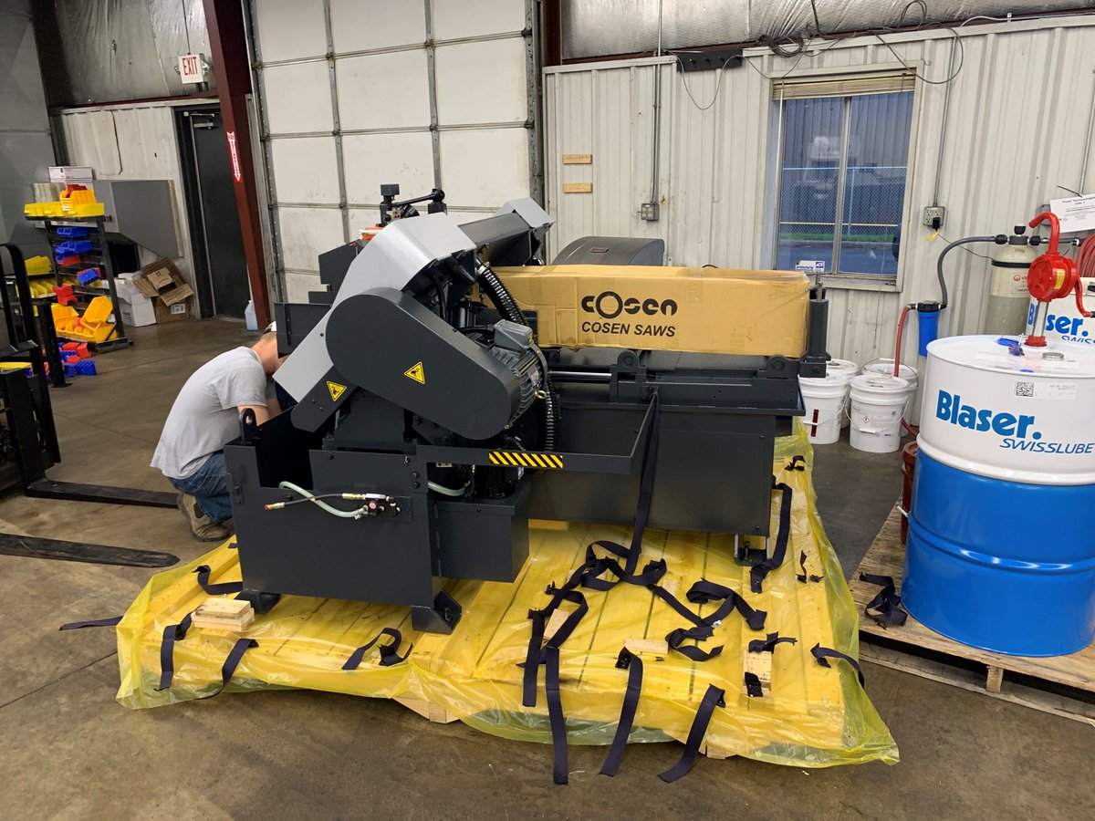 TribusTools's tweet photo. @TribusTools - Tommy here is getting our new CNC Bandsaw up and going.  This will automatically feed our steel bars through and give us precision cuts on every wrench.  #development #today https://t.co/n8v7yNsRqv