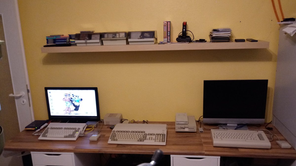 Finally a clean setup. From left to right: Amiga 600, Amiga 500, Commodore 64. just need 1 more screen now :)
