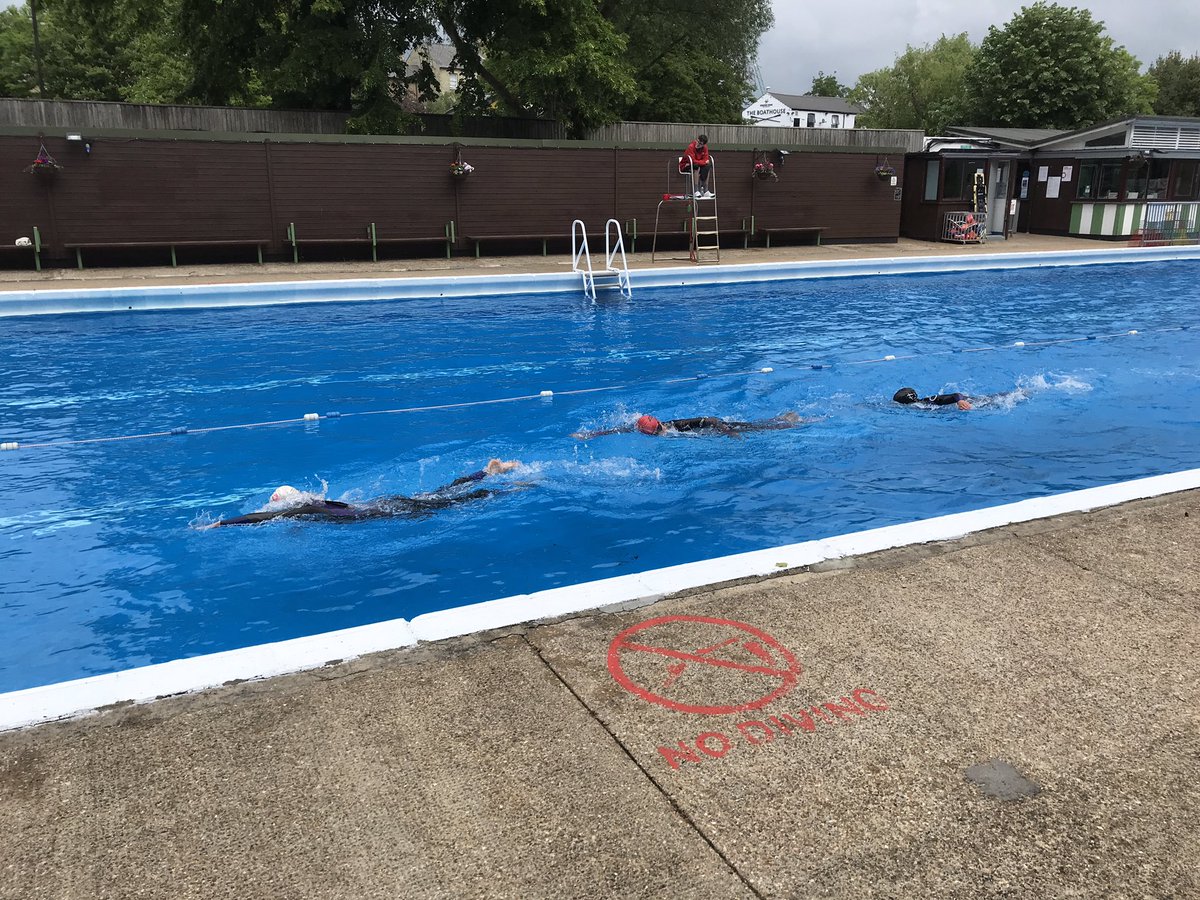 estherpauley's tweet photo. A fresh training swim in the Cambridge Lido today. @Dom_Pauley_Tri can just about feel his toes again now 🤣. Great swimming by Dom, @antoniajubb and @Bea_Pauley_Tri made even better by their @Zone3official Aspire wetsuits 🏊‍♂️🏊‍♀️ #iracezone3 https://t.co/8WEuvSFEJR