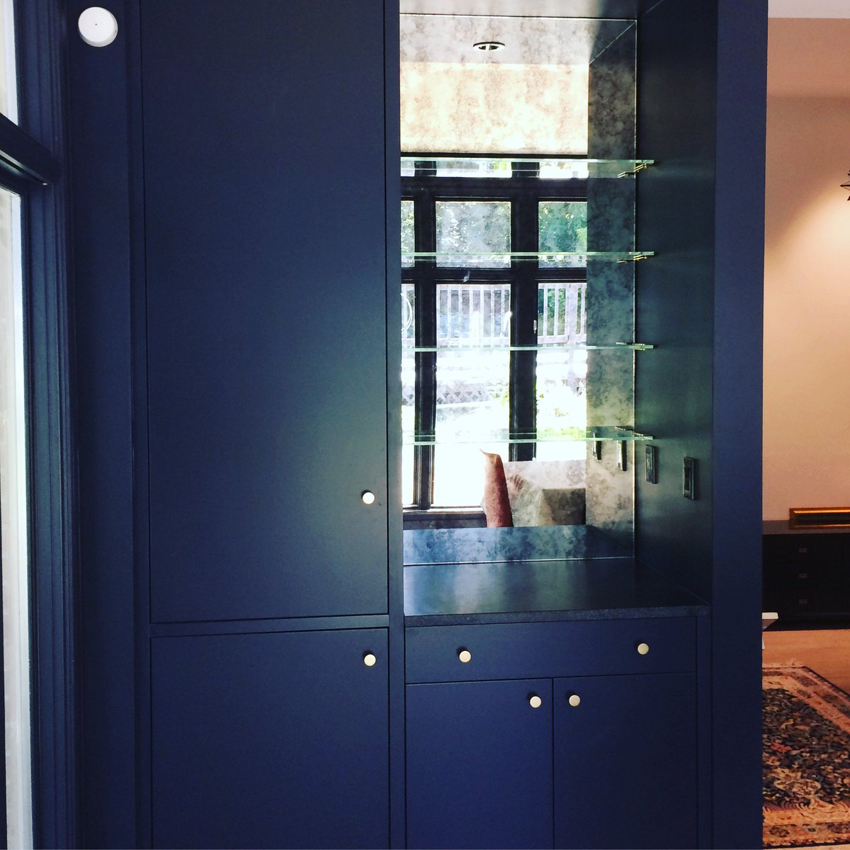 Wood bar cabinet, backed with antique mirror and low-iron glass shelves #antiquemirror #barshelves #lowironglass