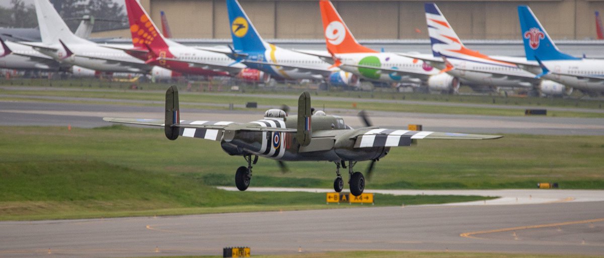 Kent_YVR's tweet photo. You never know what youโre going to catch @PaineField ๐ This is a B25 Mitchell arriving Saturday with the new Paine Field passenger terminal and a variety of aircraft in the background. #avgeek #warbird #B25D #Grumpy https://t.co/2E2naW3TfW