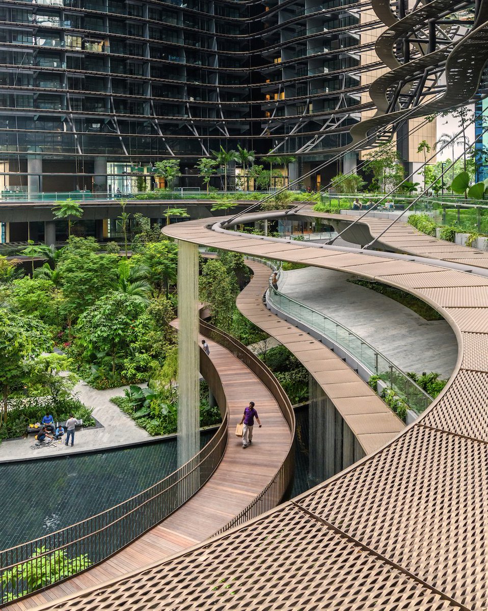 worldarchfest's tweet photo. Landscape and buildings can flow together – with abundant vegetation and flowing water Gustafson Porter + Bowman’s #WAF18 shortlisted landscape design project brings a green heart to the Marina One towers in Singapore. #WAF19 https://t.co/QUJI60wTvf